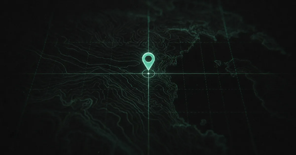 A glowing location pin on a dark topographic map marked with a latitude and longitude grid